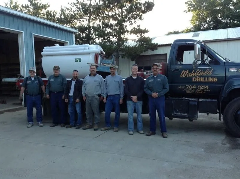 The Wahlfield Drilling crew in front of one of the company trucks.