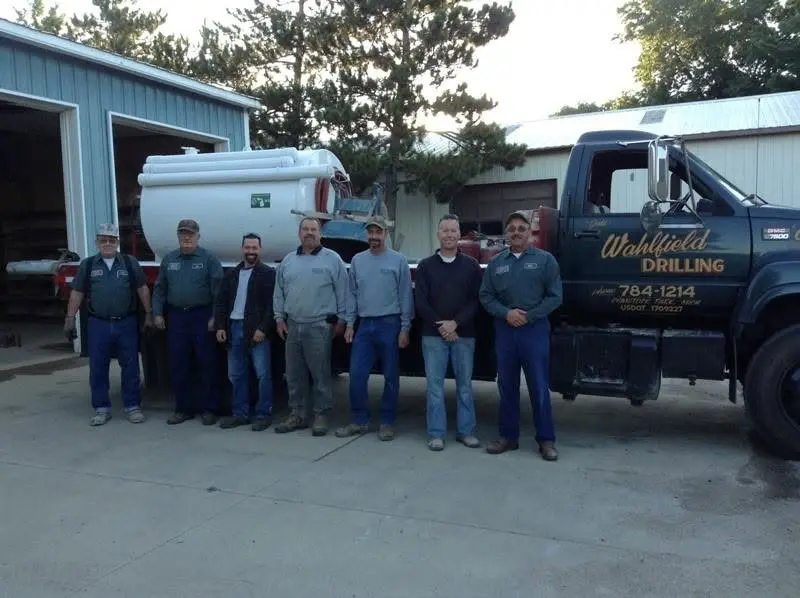 The Wahlfield Drilling crew in front of one of the company trucks.