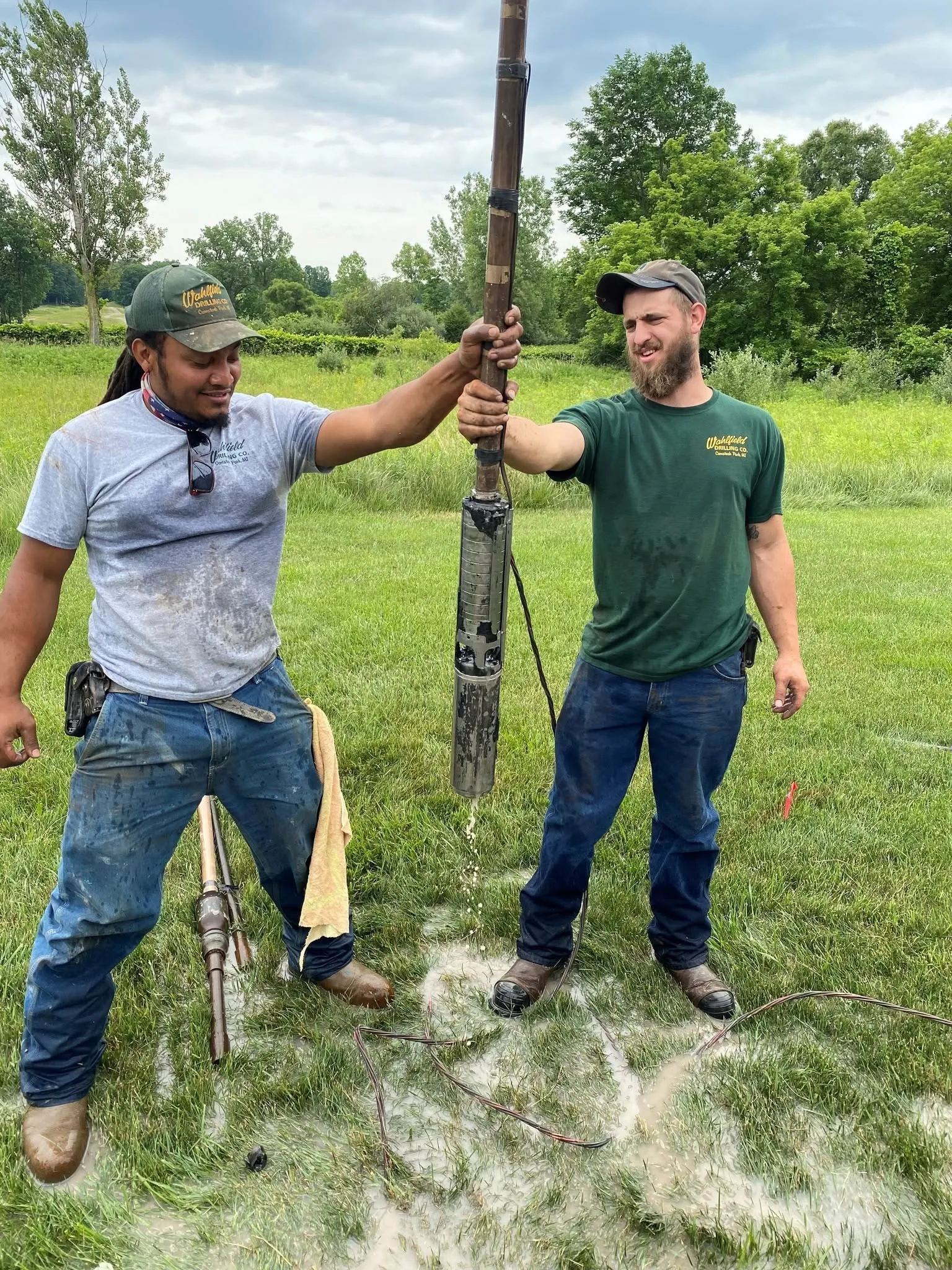 Handling a submersible pump on site before it goes down the well.