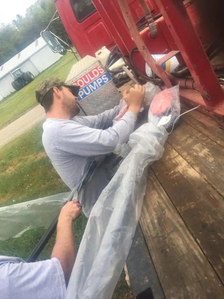 Fitting a pump on site, with the manufacturer&rsquo;s rig cover overhead.
