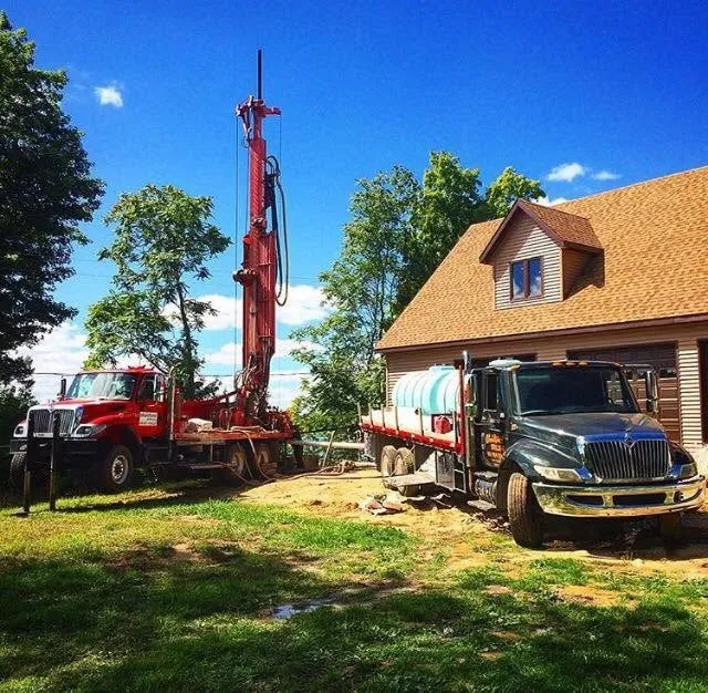 Wahlfield rig drilling a new residential well alongside the house it will supply.