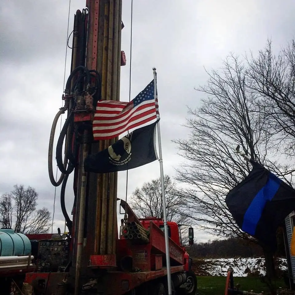 A rig under the flag on a clear day.
