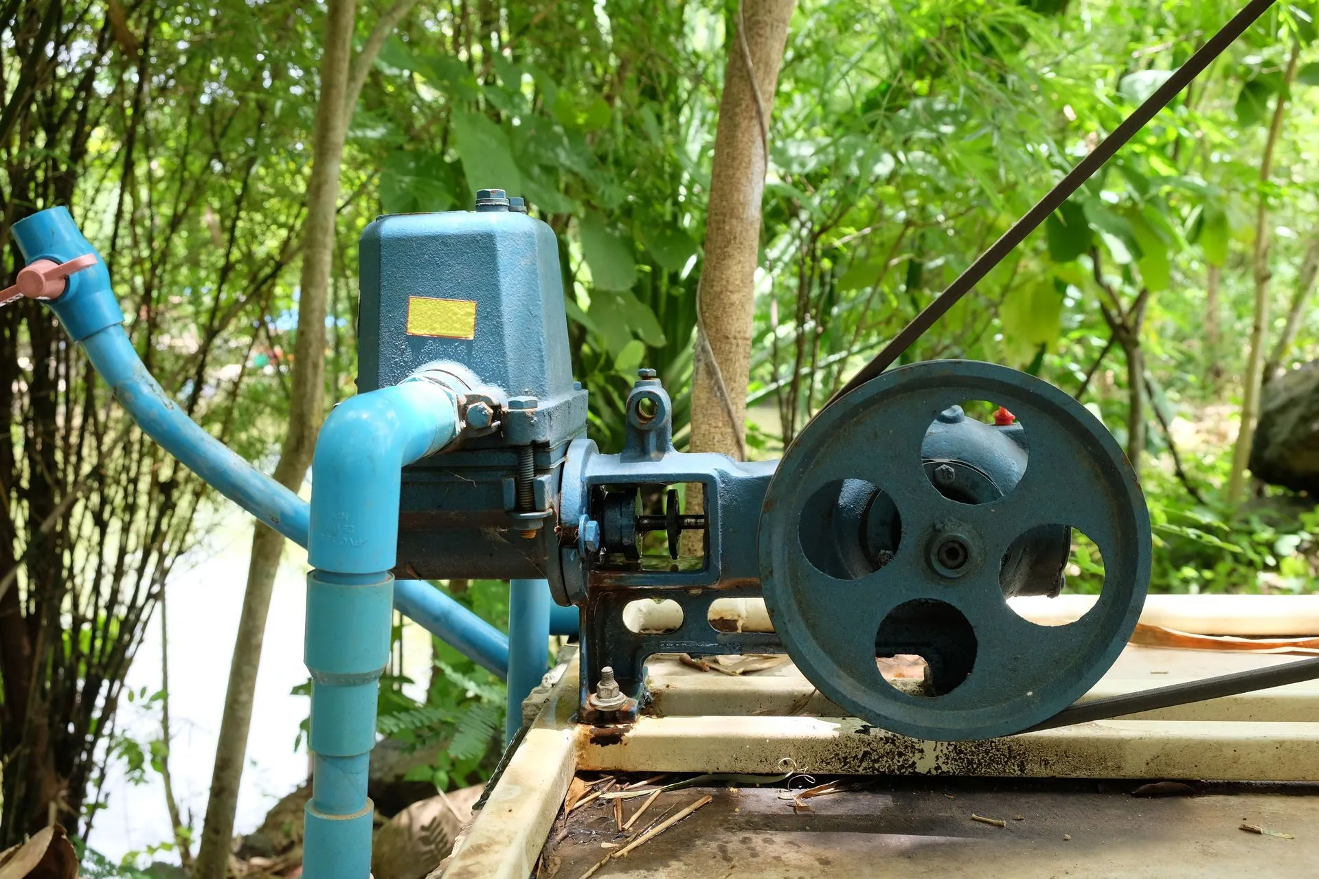 Blue well pump and valve assembly installed at a wellhead
